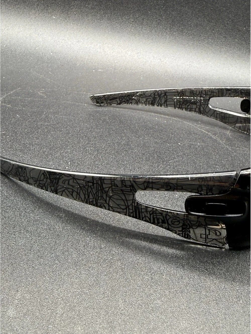 Oakley Crankcase Polished Black/Dark Grey History Text Frame (No Icons)